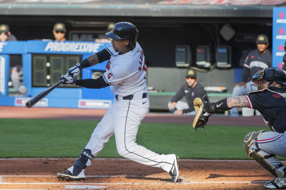 Cleveland Guardians' Jose Ramírez hits a two-run home run next to Minnesota Twins catcher Christian Vazquez during the first inning of a baseball game in Cleveland, Saturday, May 18, 2024. (AP Photo/Phil Long)