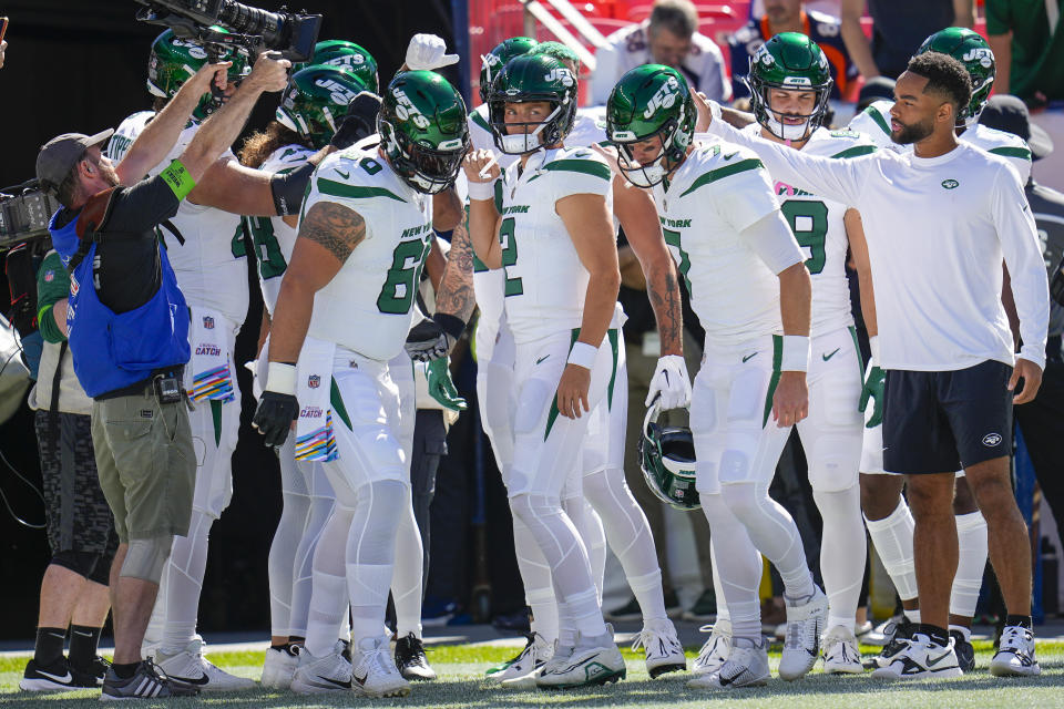 New York Jets quarterback Zach Wilson (2) huddles the team before taking the field against the Denver Broncos during an NFL football game Sunday, Oct. 8, 2023, in Denver. (AP Photo/Jack Dempsey)