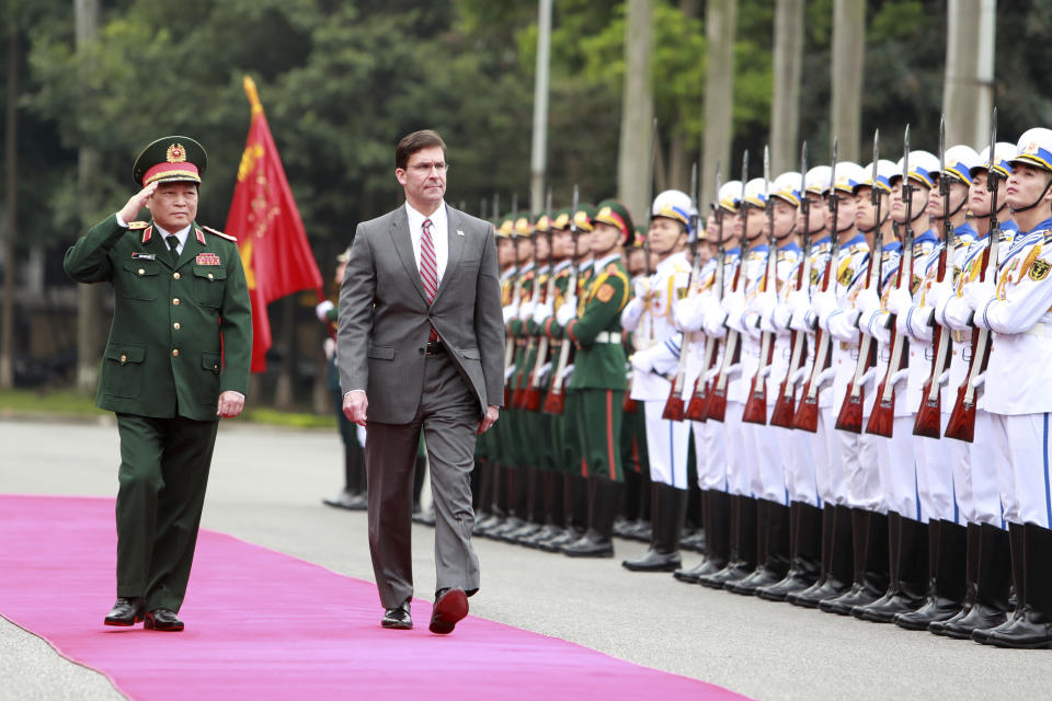 U.S. Defense Secretary Mark Esper, center, and Vietnamese Defense Minister Ngo Xuan Lich review an honor guard in Hanoi, Vietnam Wednesday, Nov. 20, 2019. Esper is on a visit to Vietnam to strengthen the military relations with the Southeast Asian nation. (AP Photo/Hau Dinh)