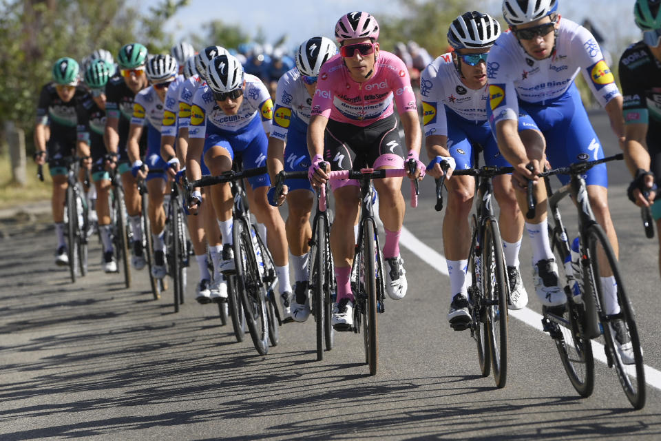 Portugal's Joao Almeida wears the pink jersey of the race overall leader as he pedals in the pack during the sixth stage of the Giro d'Italia cycling race, from Castrovillari to Matera, southern Italy, Thursday, Oct. 8, 2020. (Fabio Ferrari/LaPresse via AP)