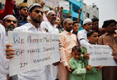 Muslims hold banners as they protest against the recent cases of mob lynching of Muslims who were accused of possessing beef, after offering Eid al-Fitr prayers in Ahmedabad, India June 26, 2017. REUTERS/Amit Dave