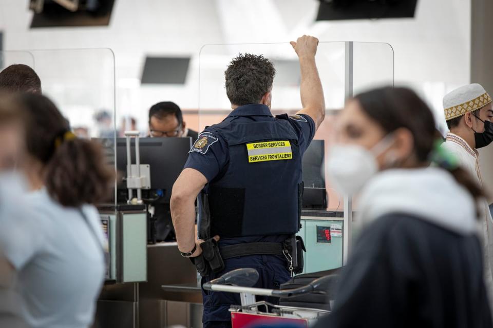 Canada Border Services Agency members are pictured at Pearson International Airport, in Toronto, on Aug. 6, 2021. The union representing some 8,500 border workers began work to rule job action Monday while The Public Service Alliance of Canada and the government negotiate a new contract just days before borders reopen to vaccinated U.S. travellers.