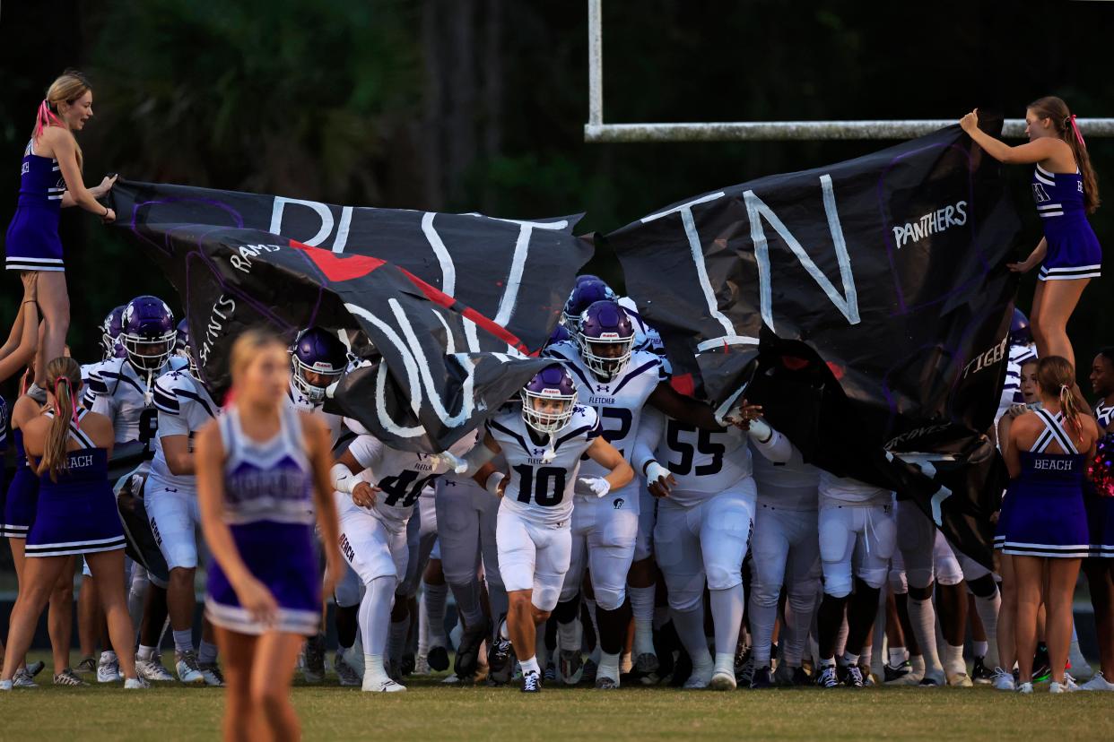 Fletcher's Brayden Weets (10) leads the team onto the field before Friday's game against First Coast.