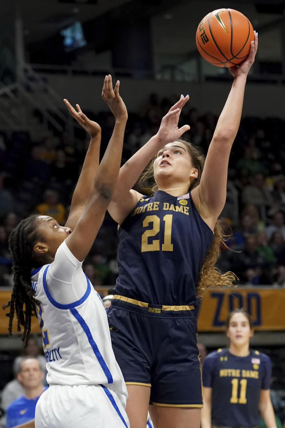 Notre Dame forward Maddy Westbeld (21) lays up the ball against Pittsburgh forward Liatu King, left, during the first half of an NCCA college basketball game in Pittsburgh, Sunday, Feb. 19, 2023. (AP Photo/Matt Freed)