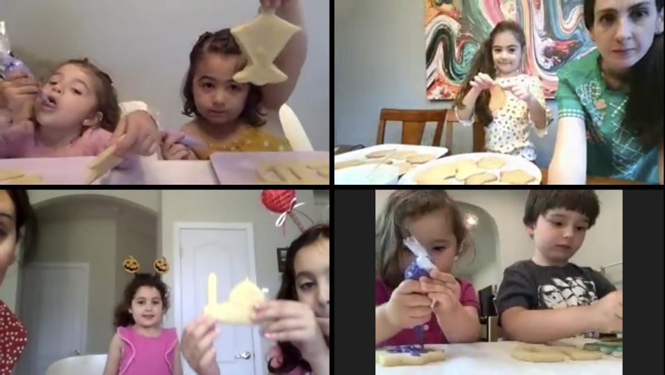 In this May 23, 2020, image from video, Liyana Mujovic, 2, and her sister Suhaila, 5, top left, decorate cookies for Eid al-Fitr with a group of friends while celebrating the end of Ramadan. (Courtesy of Hoda Rifai Bashjawish via AP)