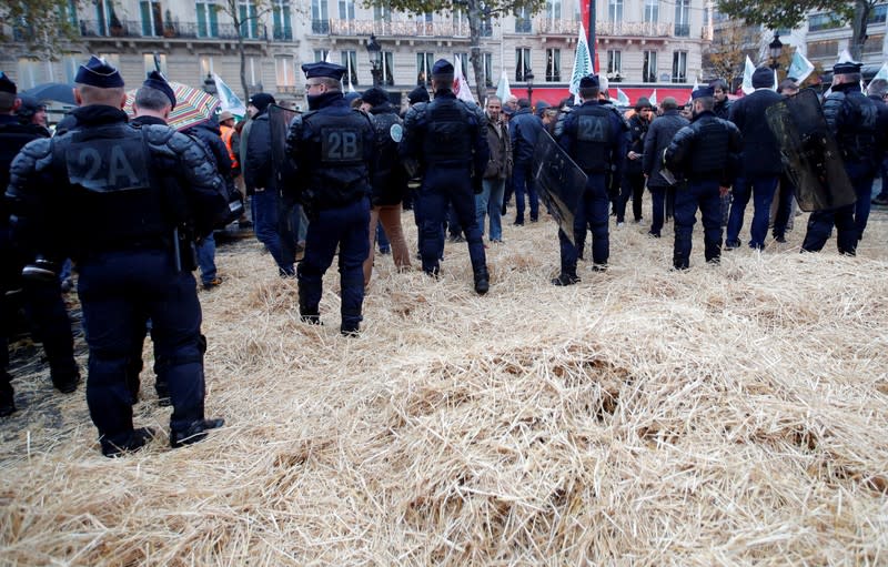 French farmers block the Champs Elysees avenue during a day of protest in Paris