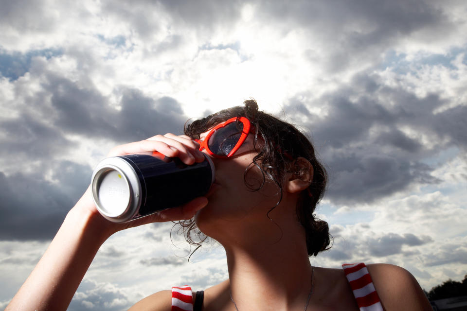 Girl drinking from a can