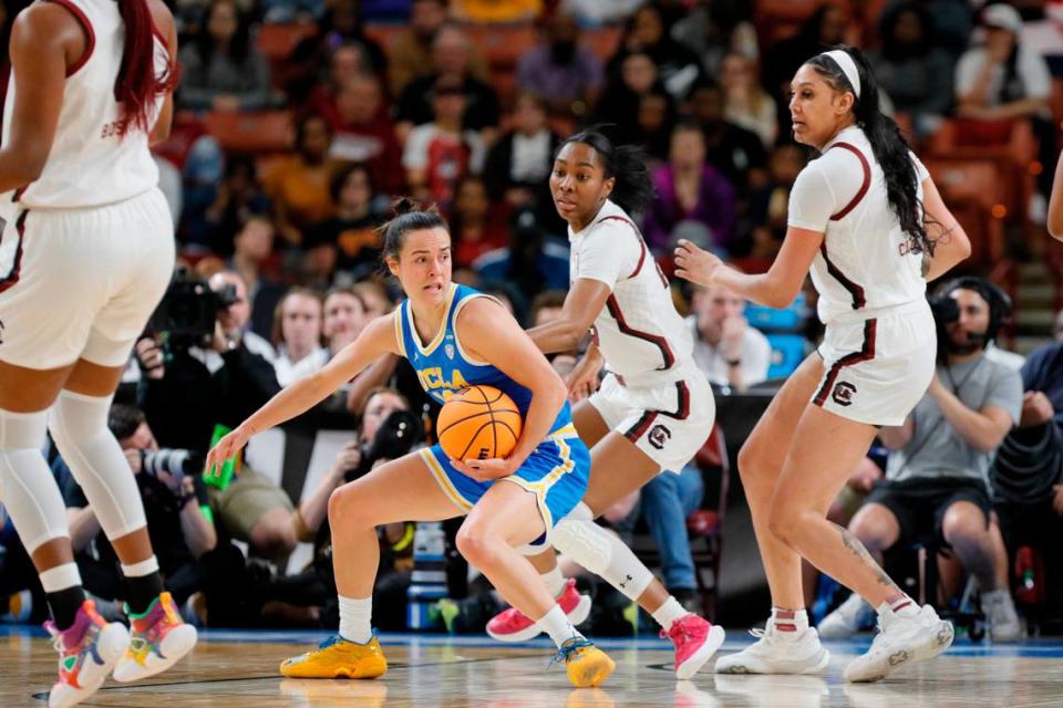 UCLA Bruins guard Gina Conti (10) is guarded by South Carolina players Bree Hall and Kamilla Cardoso in the NCAA Tournament Sweet 16 at the Bon Secours Wellness Arena in Greenville, South Carolina on Saturday, March 25, 2023.