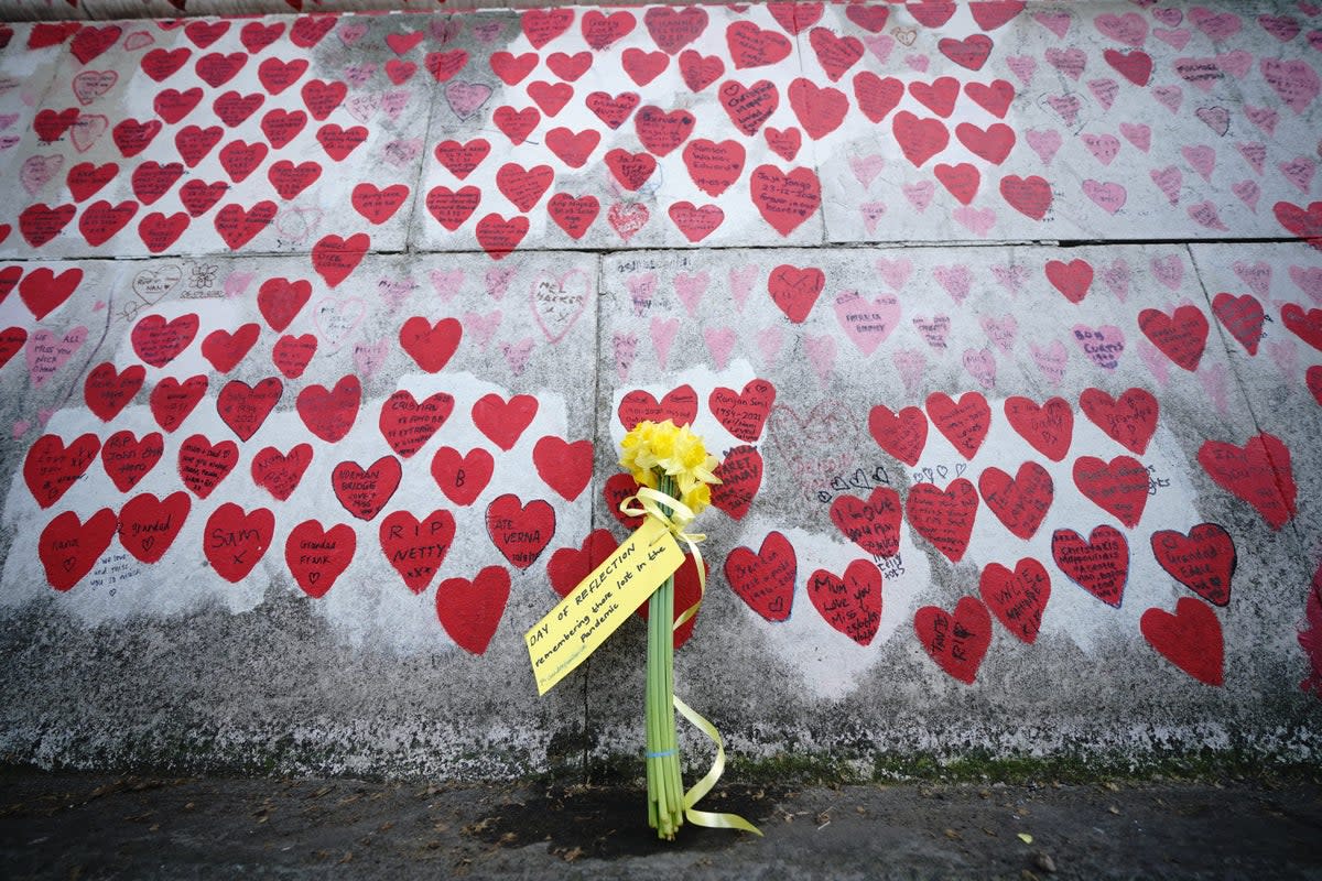 Flowers by the national Covid memorial wall in London (Yui Mok/PA) (PA Archive)