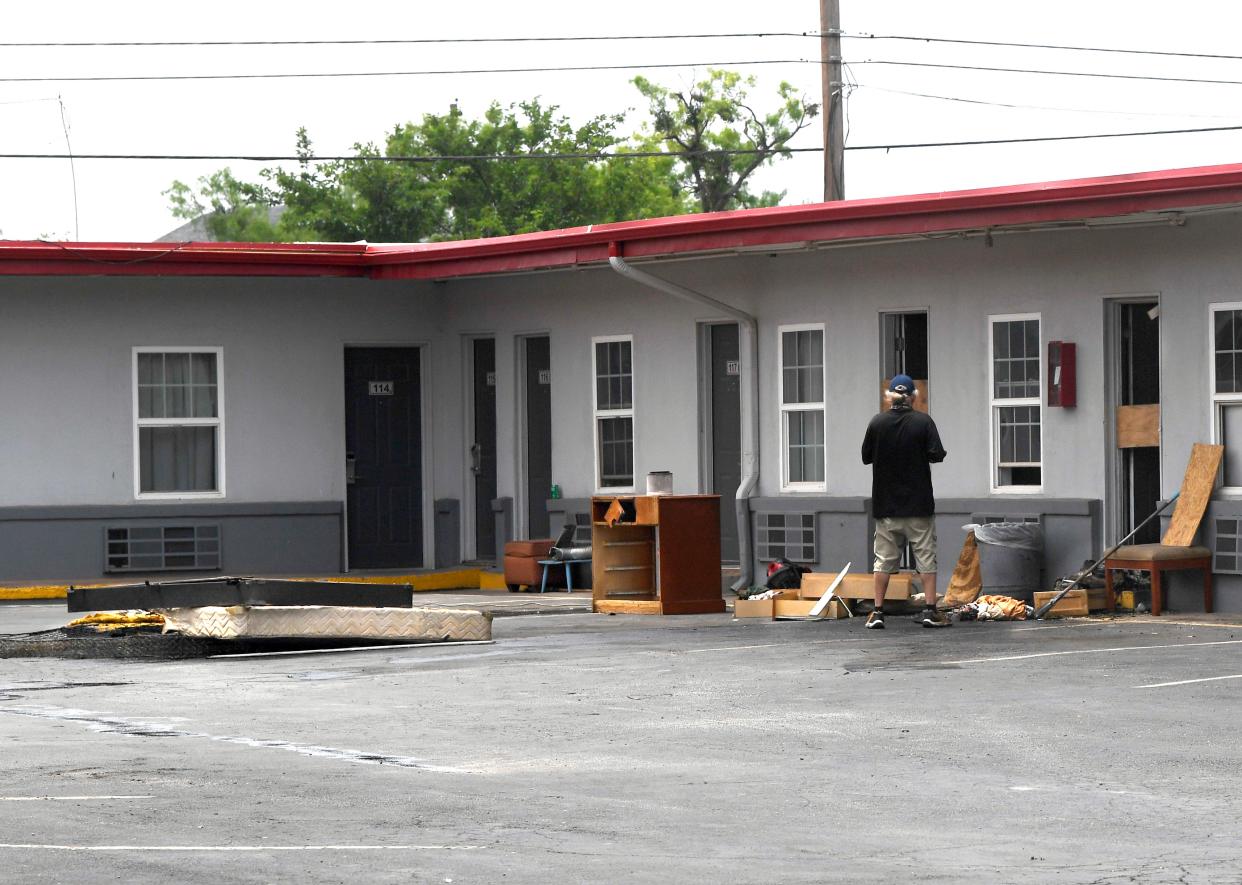 Debris after Thursday morning’s fire sits in a parking lot at Best Budget Inn on North First Street in Abilene.