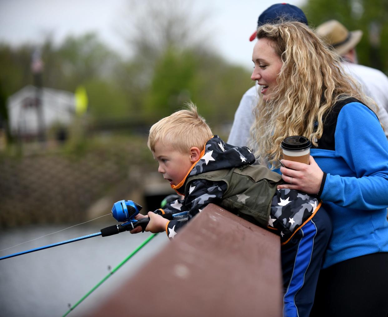 Oliver Parsons, 4, of Clinton gets a bit of guidance from mother, Lauren Oliver, as he participates in The Jack Cullen Towpath Trail Trout Derby at St. Helena Heritage Park in Canal Fulton.