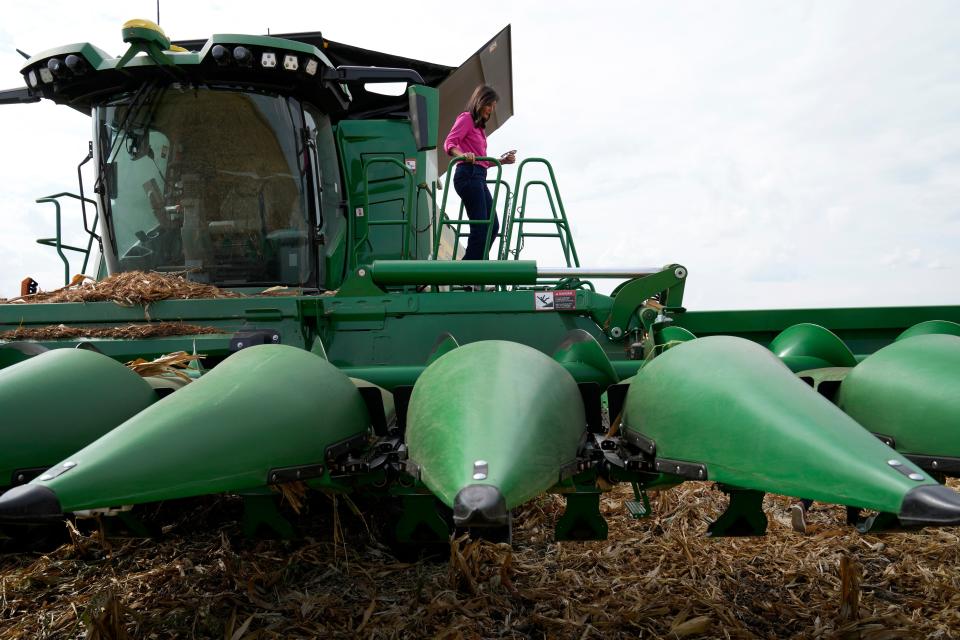 Republican presidential candidate former U.N. Ambassador Nikki Haley climbs off a combine during a tour of the Crystal Creek Enterprises farm, Friday, Sept. 15, 2023, in Grand Mound, Iowa. (AP Photo/Charlie Neibergall)