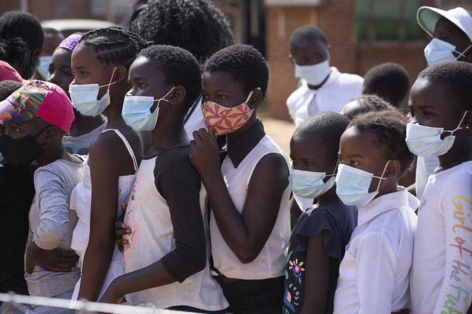 Children wear face masks while attending a social event in Epworth, Harare, in this Friday, June, 11, 2021 photo. Zimbabwe has opened up COVID-19 vaccination to the majority of teen children, while also allowing fully vaccinated people to eat in restaurants as a devastating third wave recedes and previously hesitant people take up jabs in higher numbers.(AP Photo/Tsvangirayi Mukwazhi)