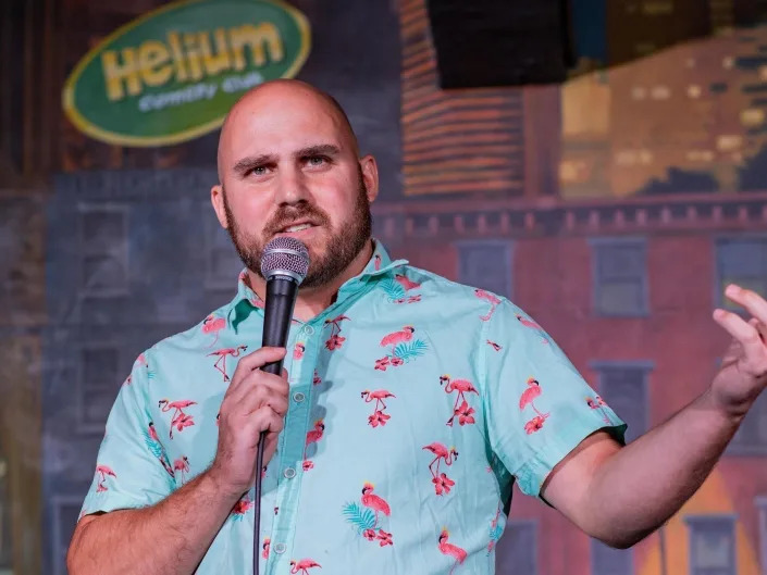 John Deary does a comedy set while holding a microphone