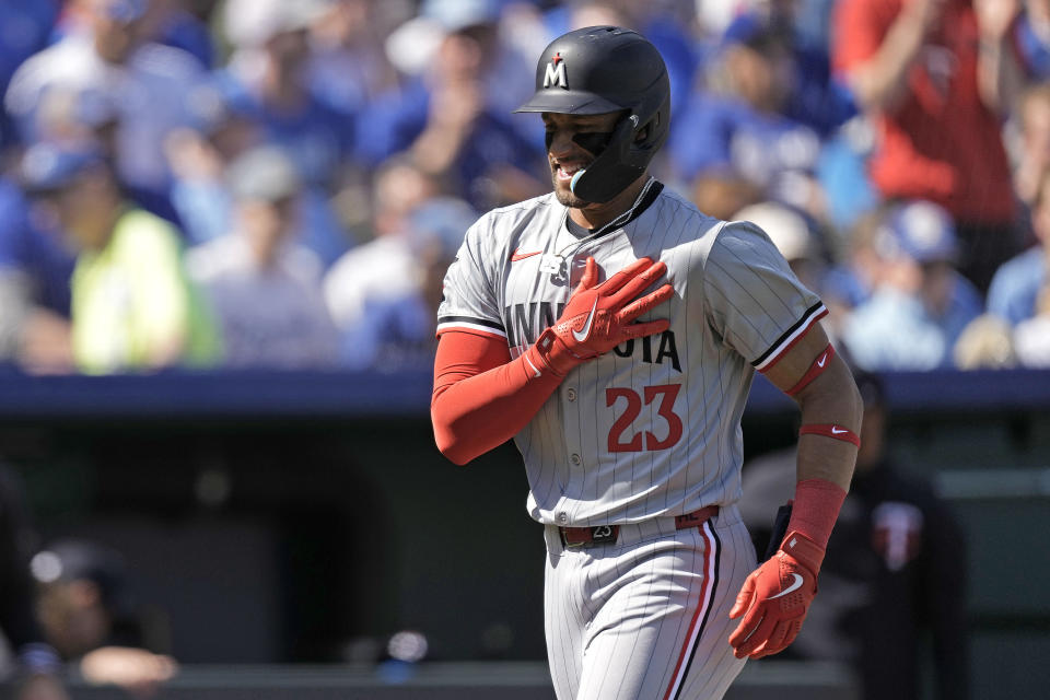 Minnesota Twins' Royce Lewis celebrates as he crosses the plate after hitting a solo home run during the first inning of a baseball game against the Kansas City Royals Thursday, March 28, 2024, in Kansas City, Mo. (AP Photo/Charlie Riedel)