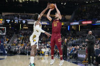 Cleveland Cavaliers forward Dean Wade (32) shoots over Indiana Pacers guard Buddy Hield (24) during the first half of an NBA basketball game in Indianapolis, Sunday, Feb. 5, 2023. (AP Photo/AJ Mast)