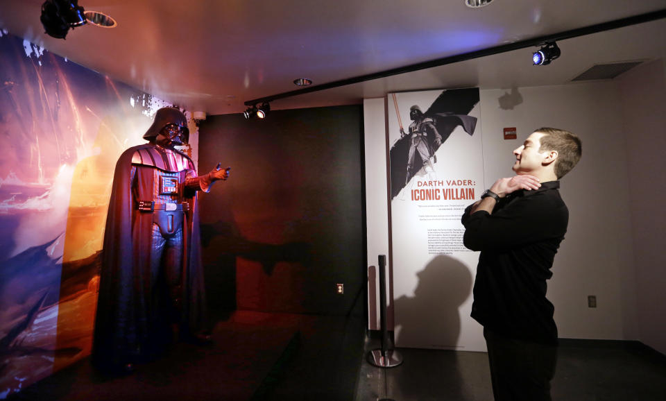 Project director Saul Drake stands-in where visitors are likely to want their photo taken in front of a Darth Vader costume on display. (AP Photo/Elaine Thompson)