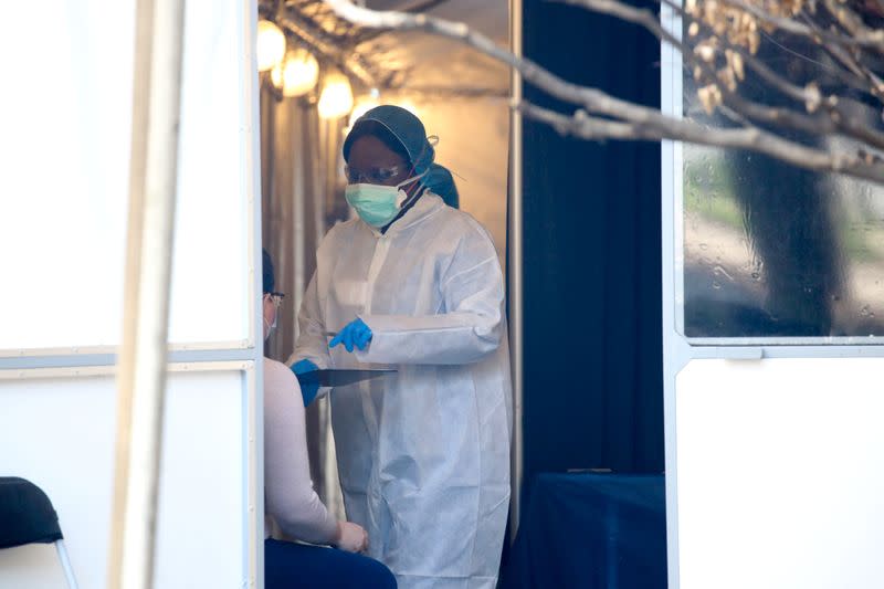 Medical professionals see walk-in patients at a Covid-19 testing tent on the grounds of the George Washington University Hospital during the coronavirus disease pandemic in Washington