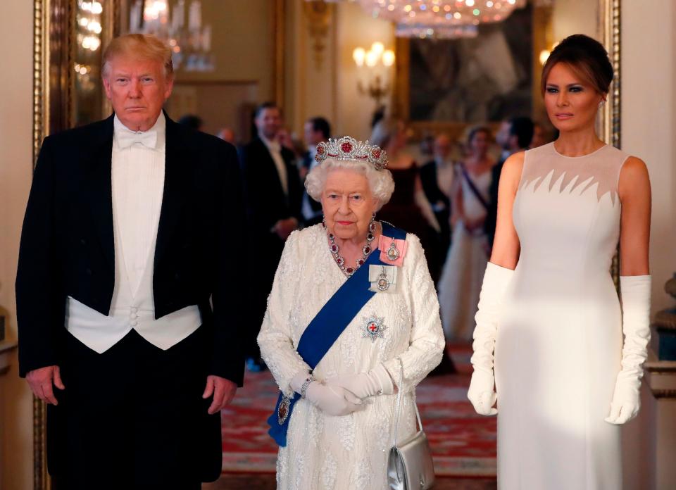 Queen Elizabeth II, President Donald Trump, and first lady Melania Trump pose for a photograph ahead of a State Banquet in the ballroom at Buckingham Palace on June 3, 2019, on the first day of the Trumps' three-day State Visit to the UK.