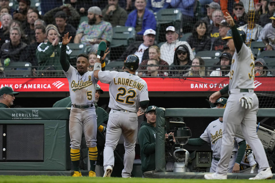 Oakland Athletics' Ramón Laureano (22) celebrates with Tony Kemp, left, after scoring against the San Francisco Giants on Jace Peterson's single during the fourth inning of a baseball game Wednesday, July 26, 2023, in San Francisco. (AP Photo/Godofredo A. Vásquez)