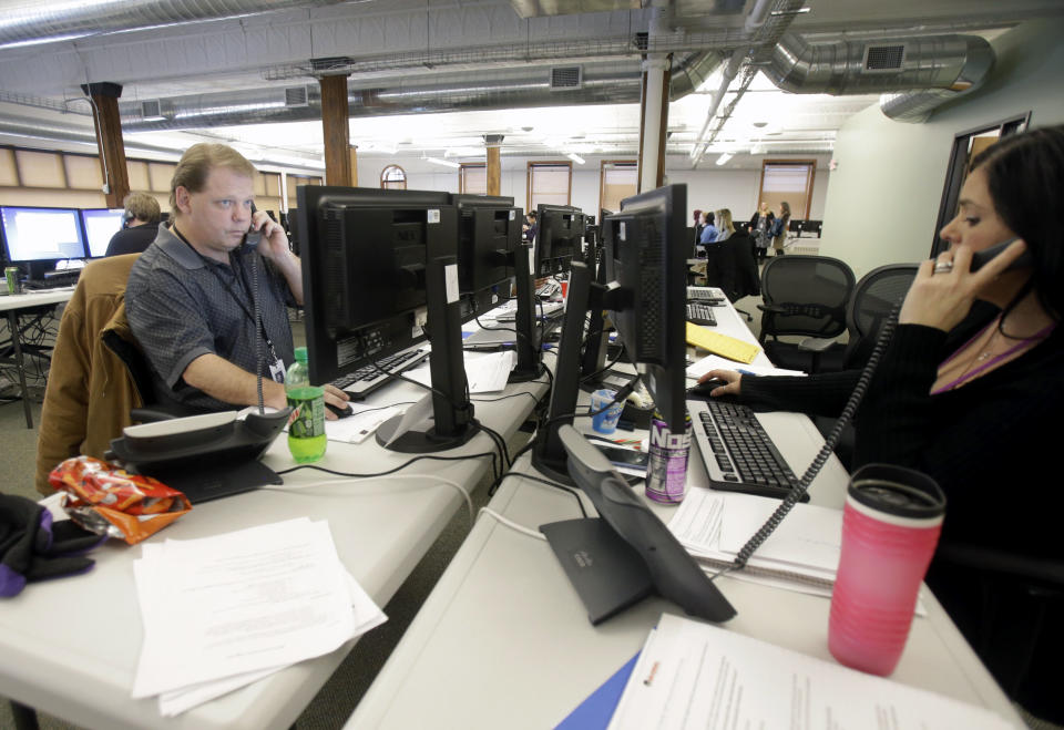 In this Dec. 31, 2013 photo, guides work the phone bank at MnSure, Minnesota's insurance marketplace in St. Paul, Minn.The 14 states running their own insurance marketplaces had their 2014 budgets footed by the federal government, but starting in 2015 were supposed to fund themselves. Most planned to do so with revenue derived from enrollments, but in states like Minnesota, the lagging pace of sign ups has thrown that into question. (AP Photo/Jim Mone)