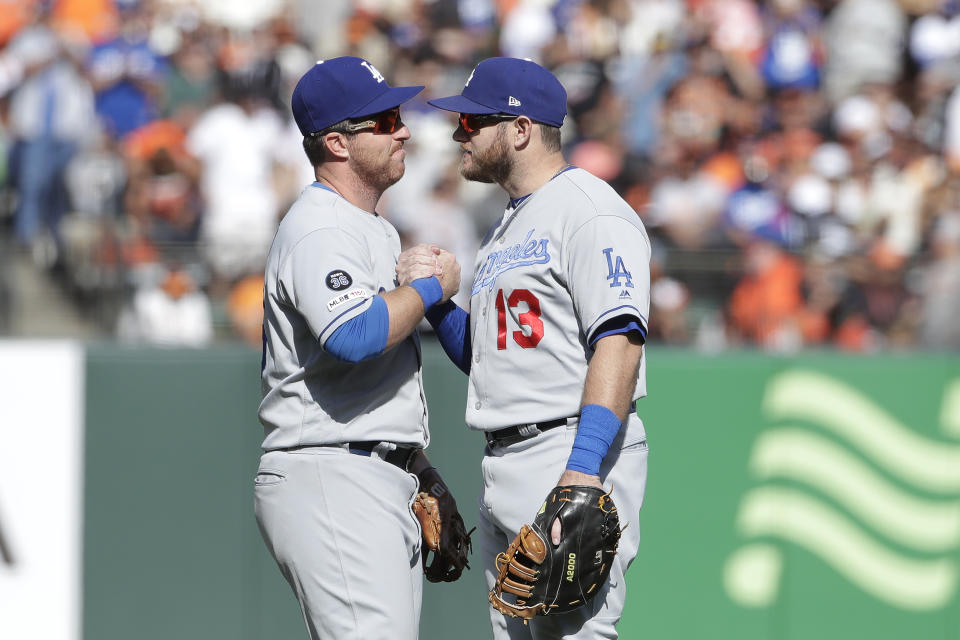 Los Angeles Dodgers' Jedd Gyorko, left, celebrates with Max Muncy after the Dodgers defeated the San Francisco Giants in a baseball game in San Francisco, Sunday, Sept. 29, 2019. (AP Photo/Jeff Chiu)