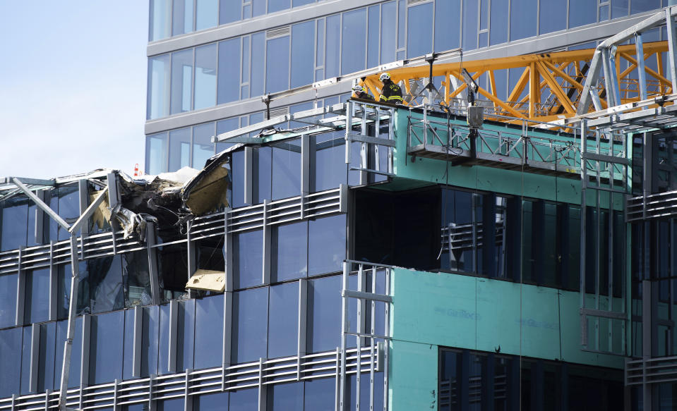 Emergency crews work the scene of a construction crane collapse near the intersection of Mercer Street and Fairview Avenue near Interstate 5 in Seattle, on Saturday, April 27, 2019. The crane was atop an office building under construction in a densely populated area. Authorities say several people have died and a few others are hospitalized after the construction crane fell onto a street in downtown Seattle. (Joshua Bessex/The News Tribune via AP)
