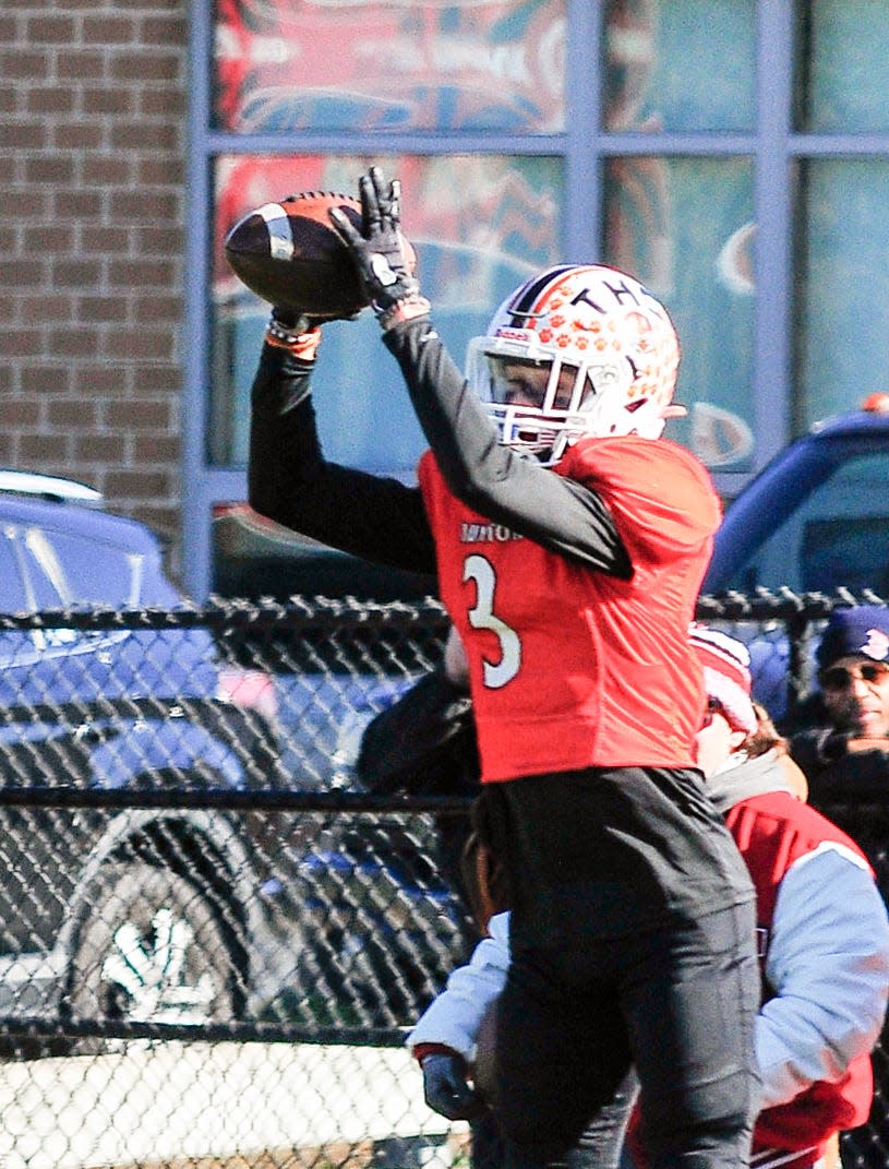 Taunton’s Jose Touron goes up for a catch during Thursday’s Thanksgiving Day game against Milford.