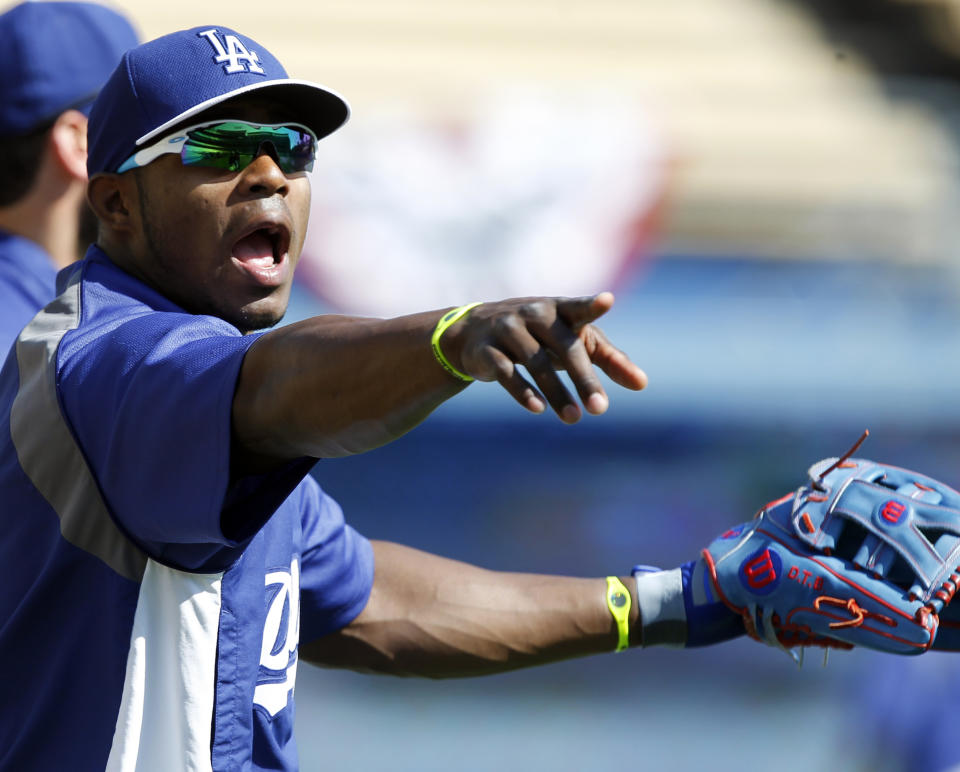 Los Angeles Dodgers' Yasiel Puig makes his point to a teammate during warm ups for a baseball game against the San Francisco Giants on Saturday, April 5, 2014, in Los Angeles. (AP Photo/Alex Gallardo)