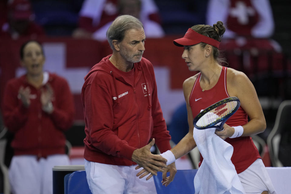 Belinda Bencic of Switzerland and captain Heinz Guenthardt talk during the semi-final match against Karolina Pliskova of Czech Republic, at the Billie Jean King Cup tennis event, at the Emirates Arena in Glasgow, Scotland, Saturday, Nov. 12, 2022. (AP Photo/Kin Cheung)