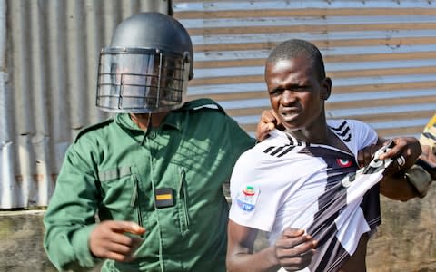 At least four people have been killed in Guinea's capital after police fired tear gas and bullets Monday to disperse thousands of opposition supporters - Credit: AP