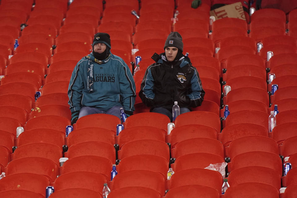 Jacksonville Jaguars fans watch the field clear after an NFL divisional round playoff football game between the Kansas City Chiefs and the Jacksonville Jaguars, Saturday, Jan. 21, 2023, in Kansas City, Mo. The Kansas City Chiefs won 27-20. (AP Photo/Charlie Riedel)