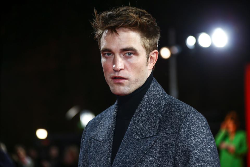 Robert Pattinson poses for photographers upon arrival for the screening of the film 'The Batman' in London Wednesday, Feb. 23, 2022. (Photo by Joel C Ryan/Invision/AP)