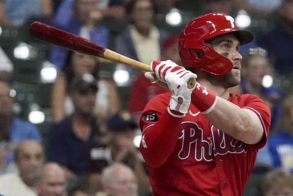 FILE - Philadelphia Phillies' Bryce Harper hits a home run during the first inning of a baseball game against the Milwaukee Brewers, Sept. 8, 2021, in Milwaukee. Harper wants the Phillies to add another big bat for the lineup. The reigning NL MVP said Monday, March 14, 2022, it would be a “downer” if the Phillies did not sign Kris Bryant, Nick Castellanos or Kyle Schwarber. (AP Photo/Morry Gash, File)