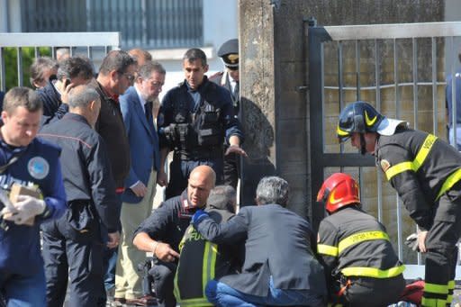 Police and rescuers work inspect the scene after a deadly blast near a school in Brindisi. Reports said investigators were looking into a possible mafia connection but also the hypothesis that it could be linked to a jealous row