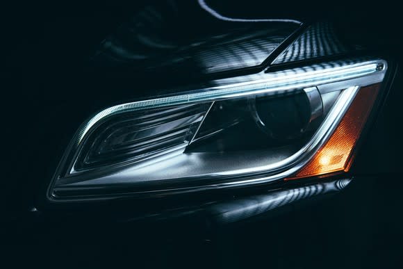 An extreme closeup of the acute angle of a headlight.