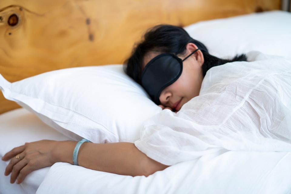 <p>Getty</p> Stock image of a person sleeping in bed with a blindfold