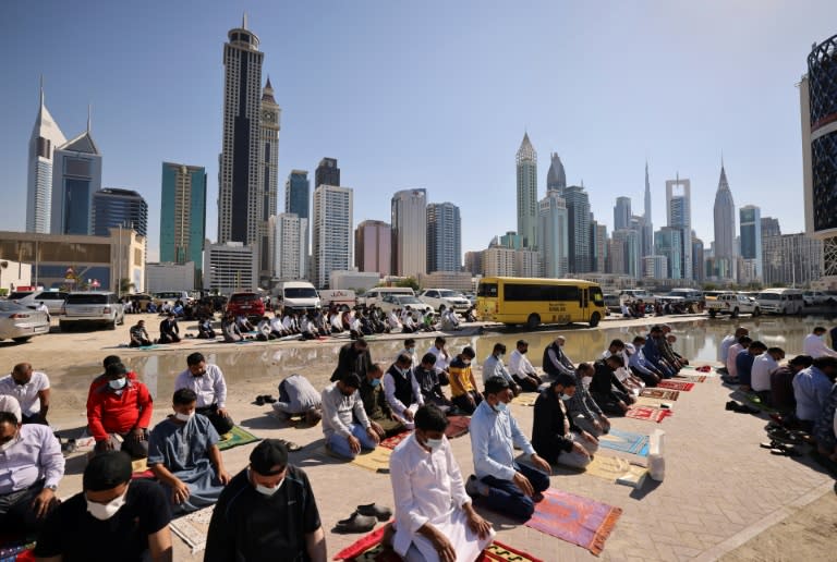 Muslim men perform Friday noon prayer in an area close to their workplace on the first working Friday in the Gulf emirate of Dubai (AFP/Karim SAHIB)