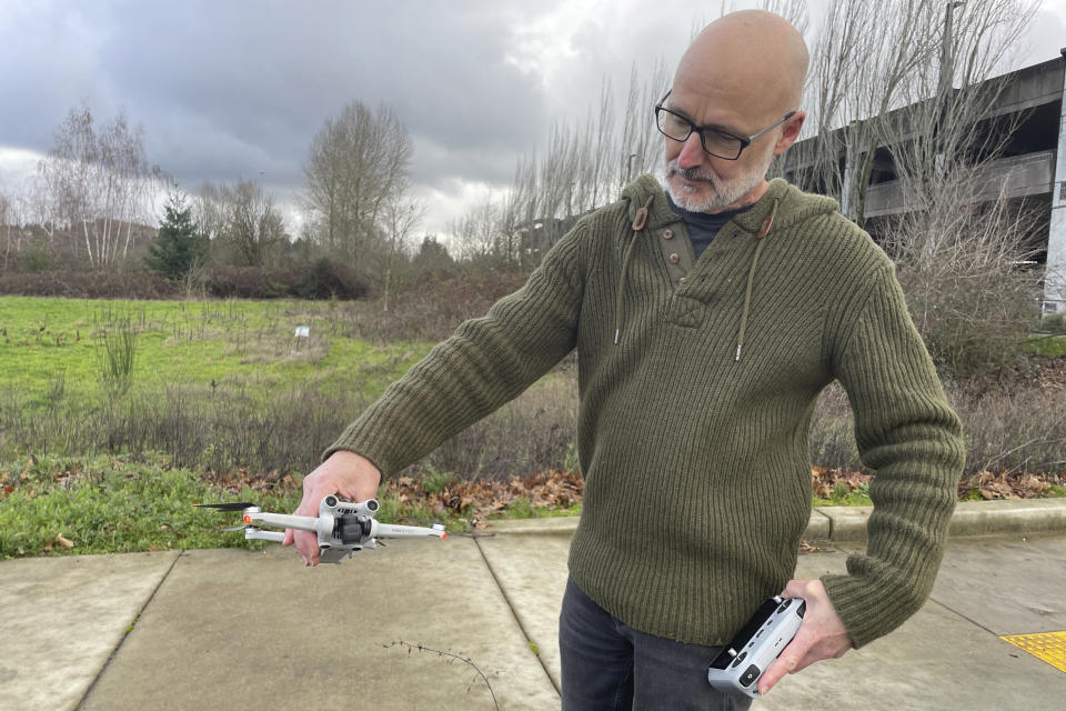 In southwest Portland, Ore., Gavin Redshaw shows the drone he used on Sunday, Jan. 7, 2024, to search for the wreckage of the fuselage of a Boeing 737 Max 9 that detached during an Alaska Airlines flight on Friday, Jan. 5. The National Transportation Safety Board estimated the fuselage may have fallen in the area. (AP Photo/Claire Rush)