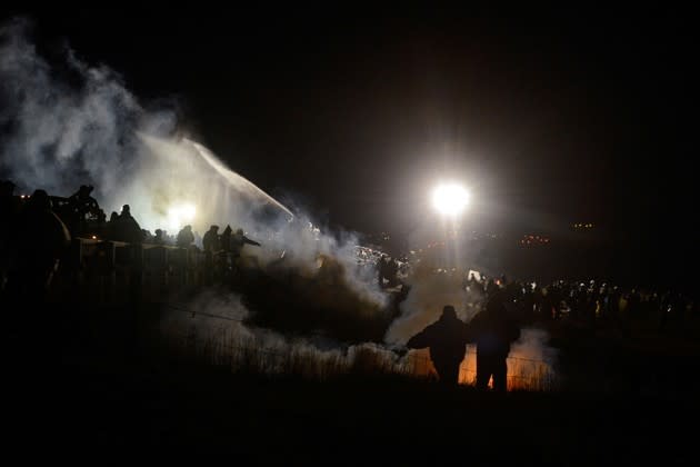 Police use tear gas and water cannons against protesters attempting to force their way through barricades at the site of the Dakota Access Pipeline on November 20, 2016. <a href="https://www.theatlantic.com/photo/2016/11/water-cannons-and-tear-gas-used-against-dakota-access-pipeline-protesters/508370/" rel="nofollow noopener" target="_blank" data-ylk="slk:More photos from the protest here;elm:context_link;itc:0;sec:content-canvas" class="link ">More photos from the protest here</a>. (Stephanie Keith / Reuters).