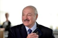 Belarusian President Alexander Lukashenko visits a polling station during the presidential election in Minsk