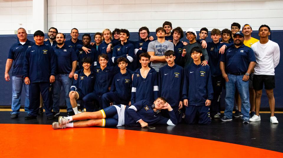 The Naples High School wrestling team poses for a photo after winning the district tournament at Barron Collier High School in Naples on Saturday, Jan. 6, 2024.