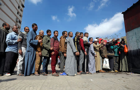 People stand in line to cast their vote during the referendum on draft constitutional amendments, at a polling station in Cairo, Egypt April 20, 2019. REUTERS/Mohamed Abd El Ghany