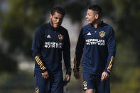Los Angeles Galaxy's Javier "Chicharito" Hernández, right, speaks with Jonathan dos Santos during a practice in Carson, Calif., Thursday, Jan. 23, 2020. (AP Photo/Kelvin Kuo)