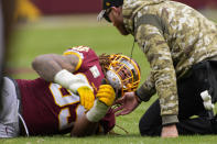 Washington Football Team defensive end Chase Young (99) is attended to after a play during the first half of an NFL football game against the Tampa Bay Buccaneers, Sunday, Nov. 14, 2021, in Landover, Md. (AP Photo/Nick Wass)