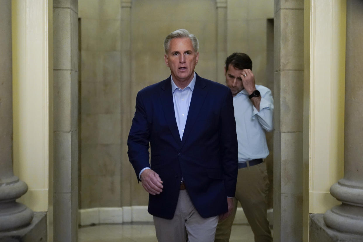 Speaker of the Kevin McCarthy, R- Calif., walks out of his office to speak with members of the press after participating in a phone call on the debt ceiling with President Joe Biden, Sunday, May 21, 2023, on Capitol Hill in Washington. Walking behind McCarthy is Rep. Garret Graves, R-La., McCarthy's top mediator in the debt limit talks. (AP Photo/Patrick Semansky)