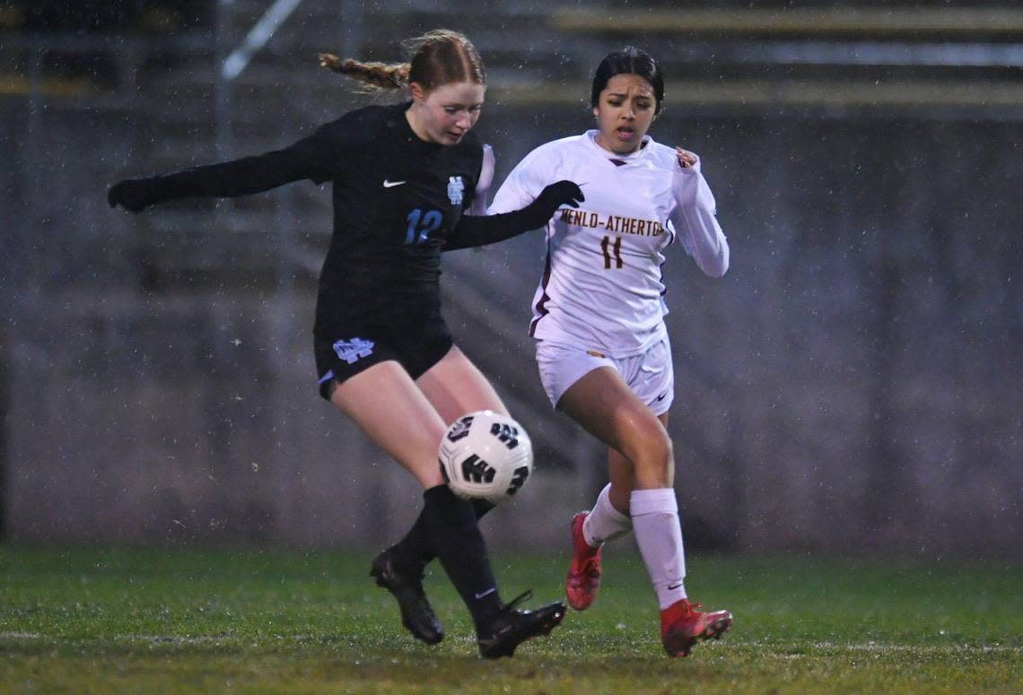 Clovis North’s Abby Pappanduros, left, and Menlo-Atherton’s Jimena Sandoval Gaona, right, in the CIF Northern California Regional girls playoff game Tuesday, Feb. 2, 2023 in Clovis.