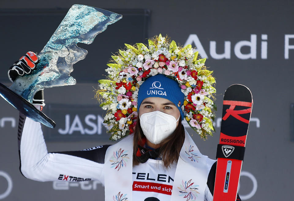Slovakia's Petra Vlhova celebrates on the podium after winning an alpine ski, World Cup women's giant slalom in Jasna, Slovakia, Sunday, March 7, 2021. (AP Photo/Gabriele Facciotti)