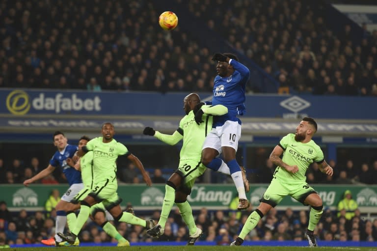 Everton's Romelu Lukaku (2R) goes up for a header against Manchester City's Eliaquim Mangala during their English League Cup semi-final 1st leg match, at Goodison Park in Liverpool, on January 6, 2016