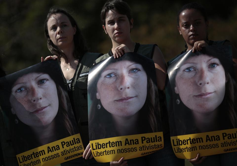 Greenpeace activists hold pictures during a protest in front of the Russian embassy in Brasilia, in support of activists arrested in Russia